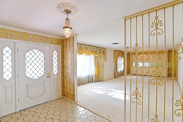 carpeted foyer with ornamental molding