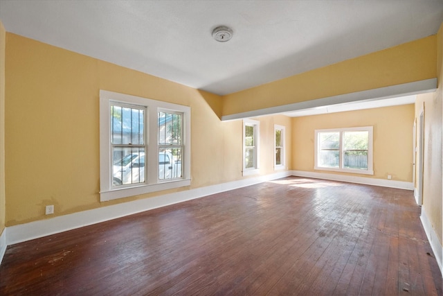 unfurnished living room with dark wood-type flooring