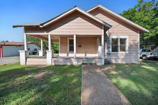 bungalow featuring a porch and a front lawn