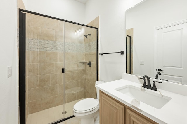 bathroom with walk in shower, vanity, and toilet