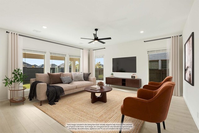 living room with ceiling fan and light wood-type flooring