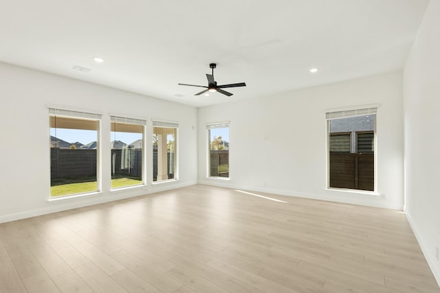 spare room featuring ceiling fan and light hardwood / wood-style flooring