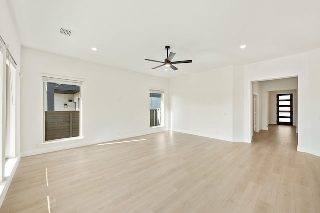 unfurnished room featuring ceiling fan and light hardwood / wood-style flooring