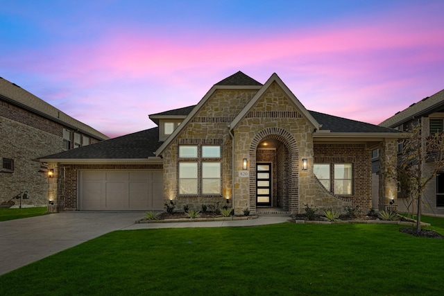 view of front facade featuring a garage and a lawn