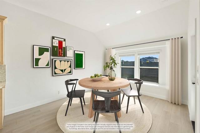 dining room featuring light hardwood / wood-style floors and lofted ceiling