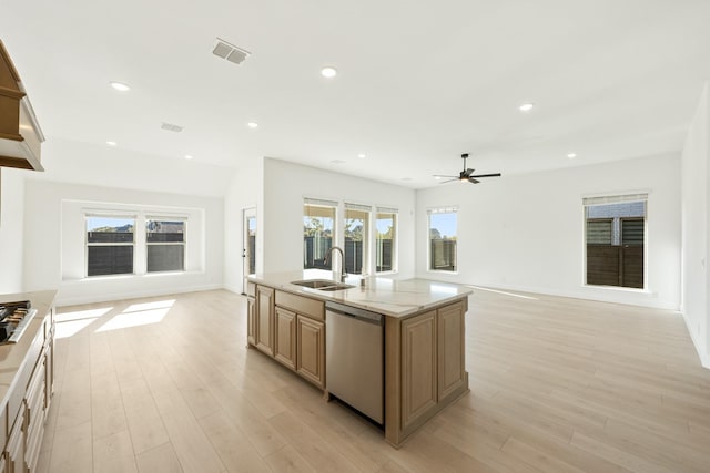 kitchen with a center island with sink, sink, ceiling fan, light hardwood / wood-style floors, and stainless steel appliances