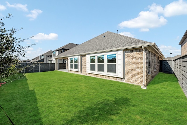 back of house featuring a yard