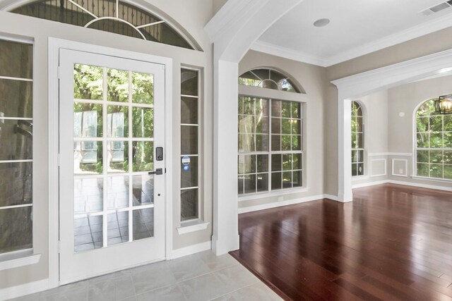 doorway to outside featuring ornamental molding and hardwood / wood-style floors