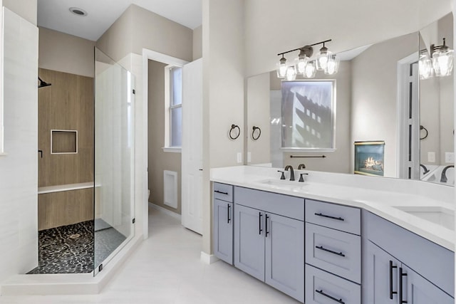 bathroom with tiled shower, vanity, and toilet