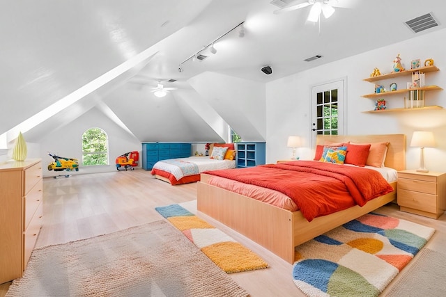 bedroom featuring ceiling fan, vaulted ceiling, and light wood-type flooring