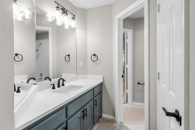 bathroom with vanity, tile patterned flooring, and washtub / shower combination