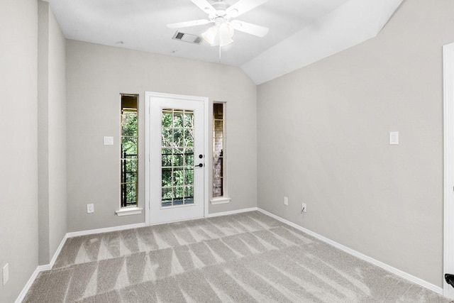 carpeted spare room with vaulted ceiling and ceiling fan