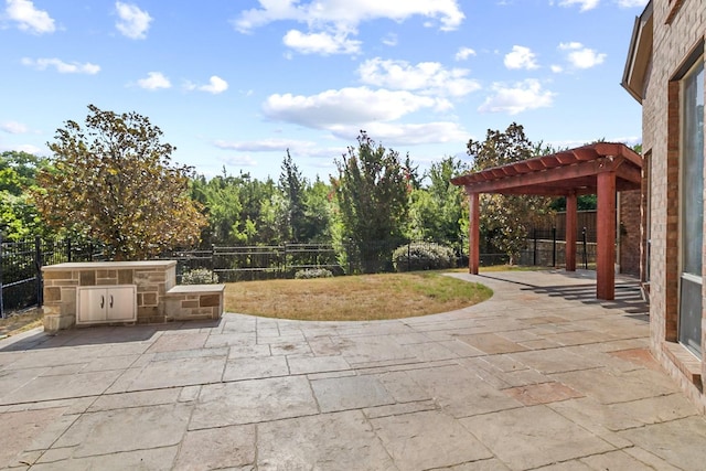 view of patio / terrace featuring a pergola and exterior kitchen