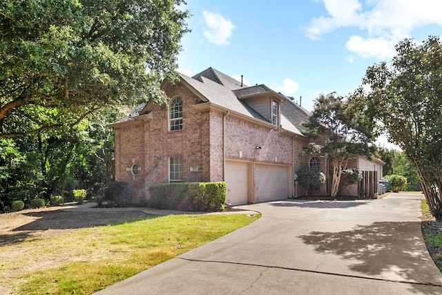 view of property exterior featuring a garage and a lawn