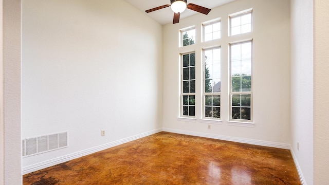 unfurnished room with concrete floors and ceiling fan