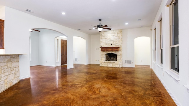 unfurnished living room featuring ceiling fan and a fireplace