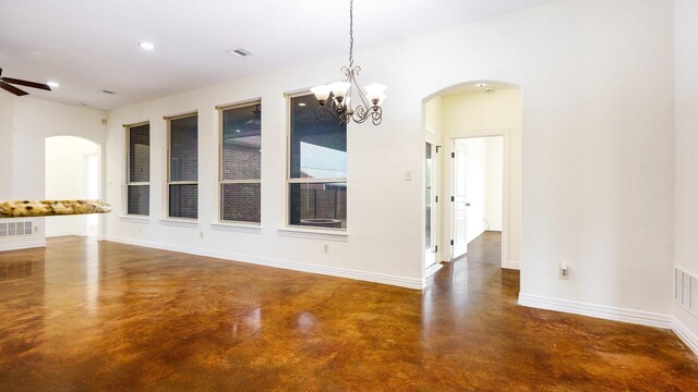 unfurnished dining area featuring ceiling fan with notable chandelier