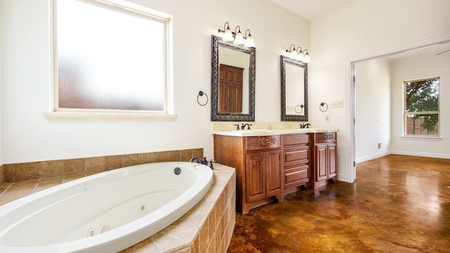 bathroom with vanity, tiled bath, and concrete flooring