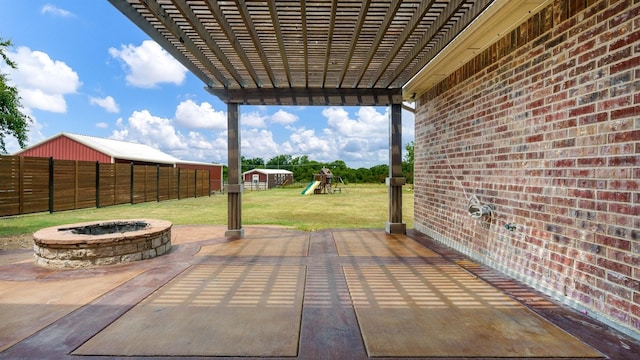 view of patio featuring an outdoor fire pit and a playground