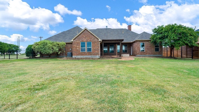 back of house featuring cooling unit and a yard