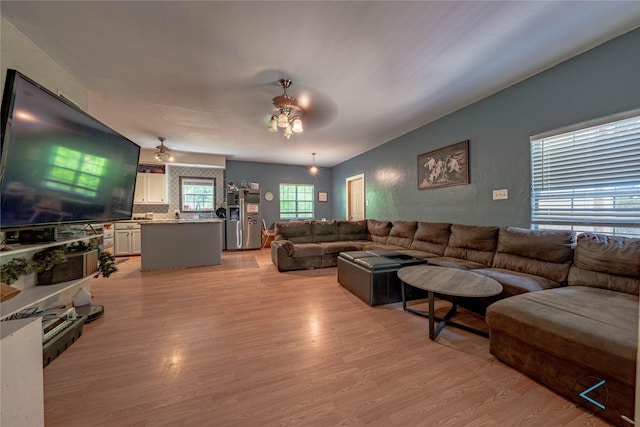 living room featuring ceiling fan and light hardwood / wood-style flooring