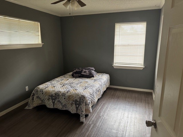 bedroom featuring ornamental molding, hardwood / wood-style floors, a textured ceiling, and ceiling fan