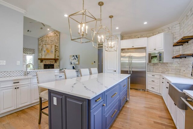 kitchen with built in appliances and white cabinetry