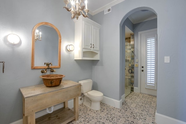 bathroom with sink, a tile shower, tile patterned floors, toilet, and ornamental molding