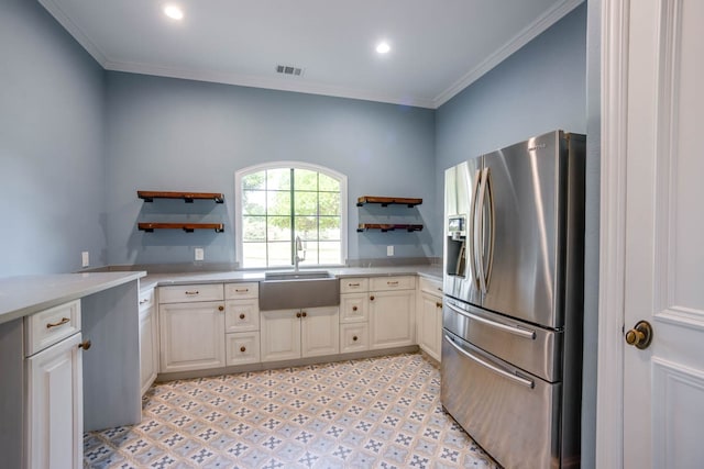 kitchen featuring light tile patterned flooring, sink, ornamental molding, and stainless steel fridge with ice dispenser