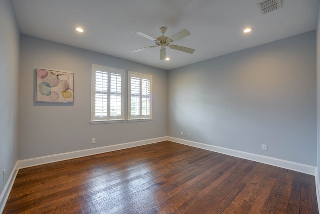 empty room with dark wood-type flooring and ceiling fan