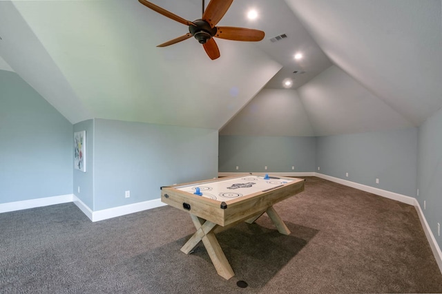 recreation room with lofted ceiling, dark colored carpet, and ceiling fan