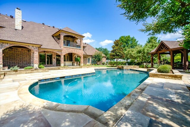 view of pool with a patio area and a gazebo