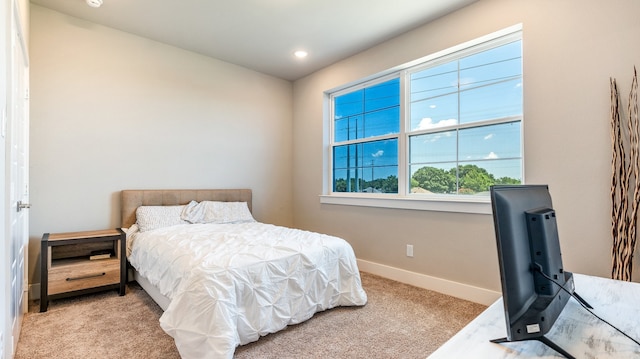 bedroom featuring light colored carpet