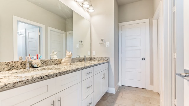 bathroom featuring tile patterned floors and dual bowl vanity