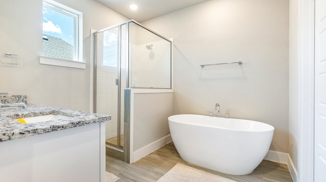 bathroom featuring shower with separate bathtub and vanity