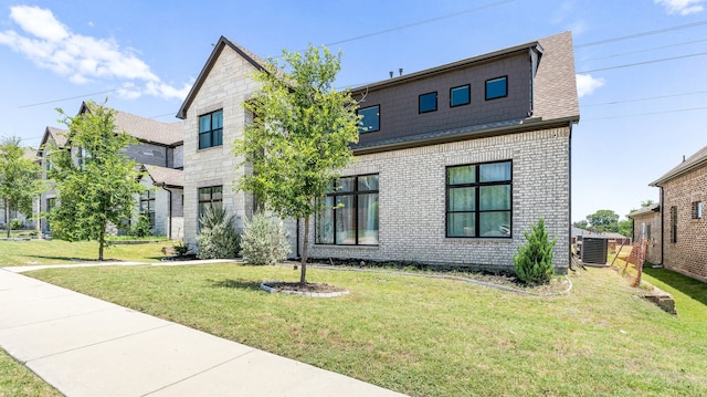 view of front facade with cooling unit and a front lawn