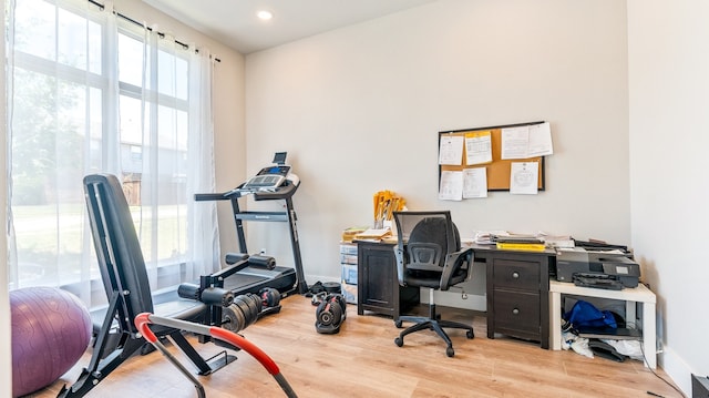 home office with light hardwood / wood-style flooring