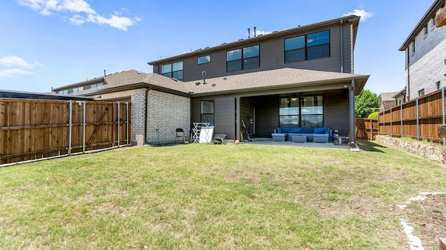 back of property with an outdoor living space, a yard, and a patio area