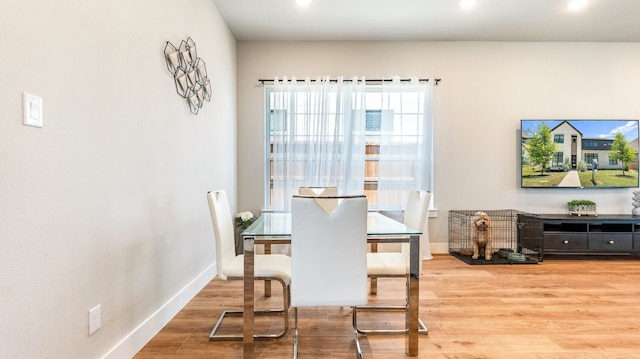 dining space featuring wood-type flooring