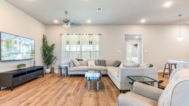 living room with ceiling fan and wood-type flooring