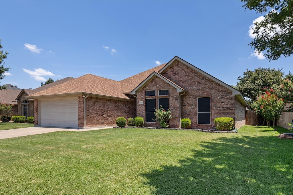 ranch-style house with a front lawn and a garage