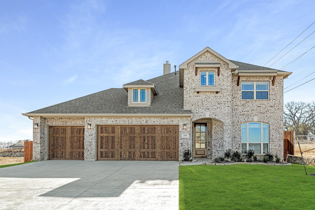 view of front facade with a garage and a front lawn