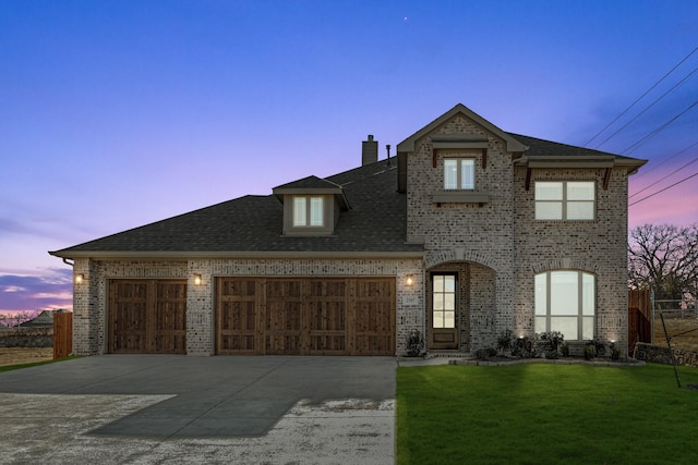 view of front of home featuring a yard and a garage