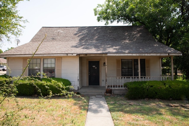 view of front of home with covered porch and a front yard