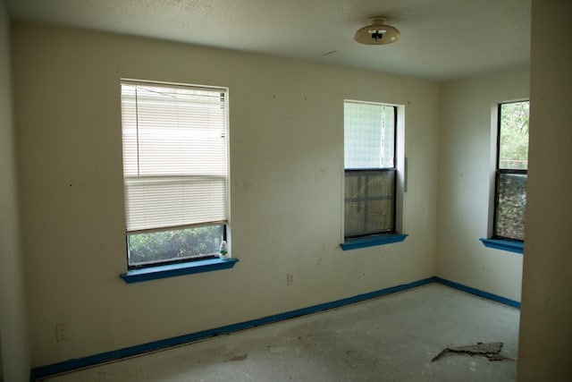 unfurnished room featuring a wealth of natural light