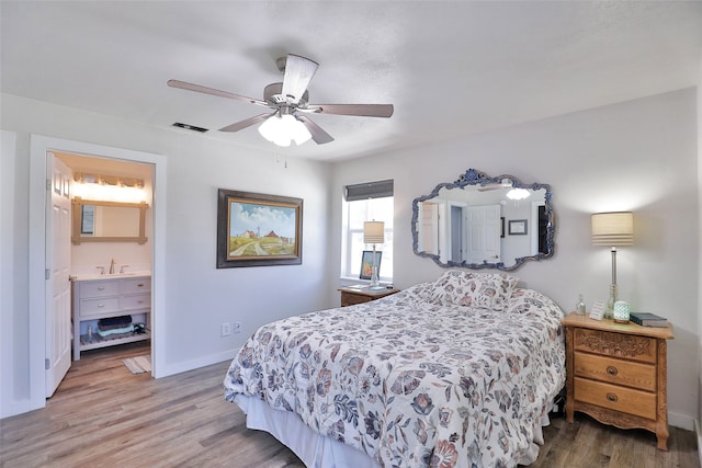 bedroom featuring ceiling fan, sink, connected bathroom, and wood-type flooring