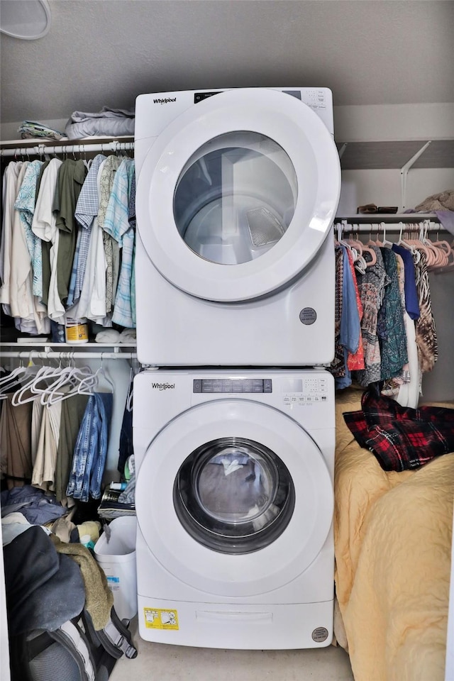 laundry area with laundry area and stacked washer and clothes dryer