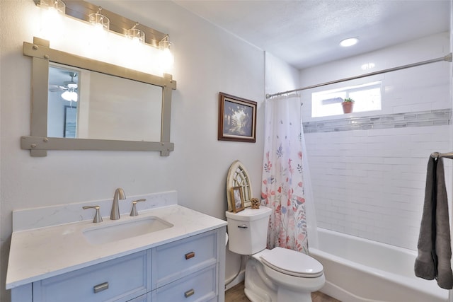 full bathroom with vanity, shower / bathtub combination with curtain, ceiling fan, toilet, and a textured ceiling