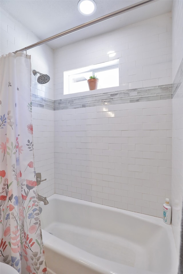 bathroom featuring shower / tub combo with curtain