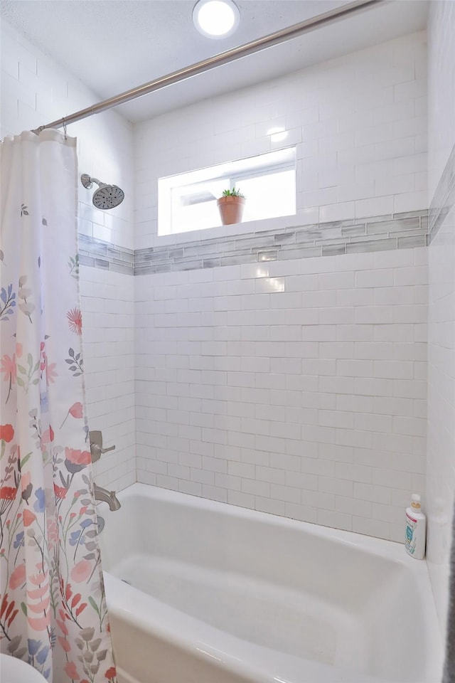 full bath featuring shower / tub combo with curtain